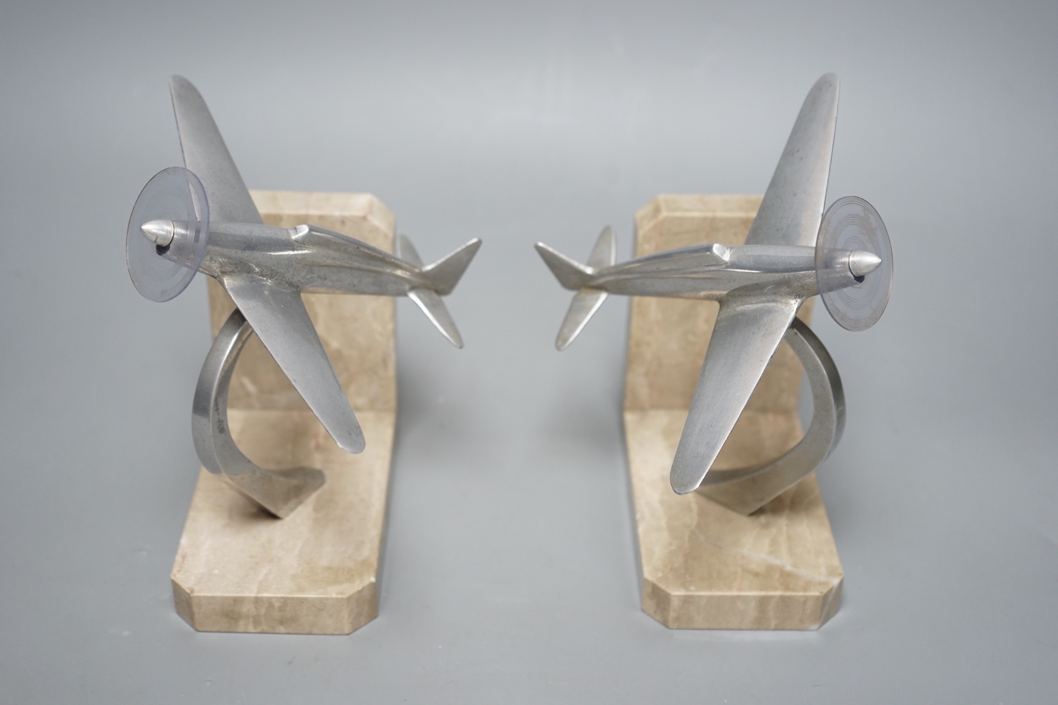 A pair of Art Deco chrome plated and marble aircraft book-ends, 17cm